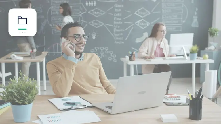 Professional in a modern office with a laptop and phone with organised digital receivables folder – editorial image for “Business debt collection: how accounts receivable teams prepare cases correctly”.